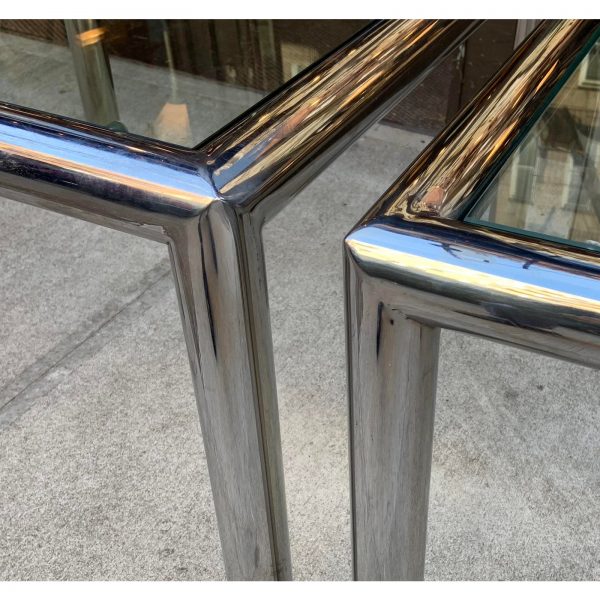 Pair of "Tubo" side tables by John Mascheroni. Constructed of beautifully welded polished aluminum 2 1/2" cylinders with 3/8" glass that floats within the frame. Tables retain their adjustable, self leveling glides.