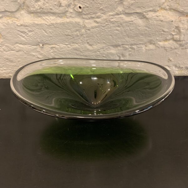 Mid-century aqua blue glass curved bowl by Per Lutken for Holmegaard of Denmark. A flat base and circular form features curved wave-like rounded edges. Handblown in Aqua grey glass with variances in color. Signed and excellent condition