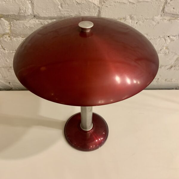 The Art Deco/Machine Age, Mid-Century Mooncrest sight light table lamp is an icon of American Post-War design. It was manufactured by the Smith Metal Arts Company of Buffalo, NY and incorporates designer, Laurence E. Corcoran's patented aluminum indirect reflector under the shade. This design was produced in several colorways and this particular example of this famous lamp is in a rich burgundy and silver anodized finish. Under the shade it has the Mooncrest logo decal and the words patent applied for and under the reflector has the period underwriters approval decal containing the Smith Metal Arts credit. This iconic lamp is in amazing all-original condition, retains its original felt to the underside of the base The Art Deco/Machine Age, Mid-Century Mooncrest sight light table lamp is an icon of American Post-War design. It was manufactured by the Smith Metal Arts Company of Buffalo, NY and incorporates designer, Laurence E. Corcoran's patented aluminum indirect reflector under the shade. This design was produced in several colorways and this particular example of this famous lamp is in a rich burgundy and silver anodized finish. Under the shade it has the Mooncrest logo decal and the words patent applied for and under the reflector has the period underwriters approval decal containing the Smith Metal Arts credit. This iconic lamp is in amazing all-original condition, retains its original felt to the underside of the base